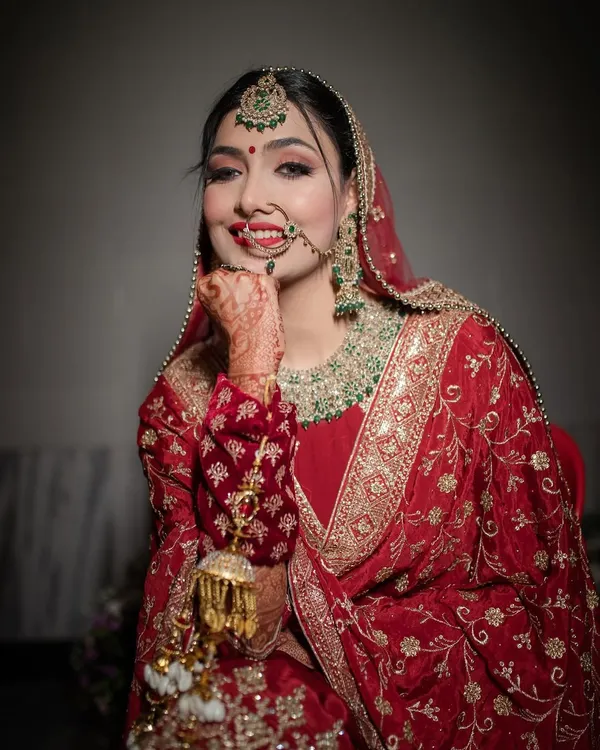 The best Punjabi bride. Her happy, playful pose and beautiful smile perfectly capture the joyful spirit of a Punjabi wedding.