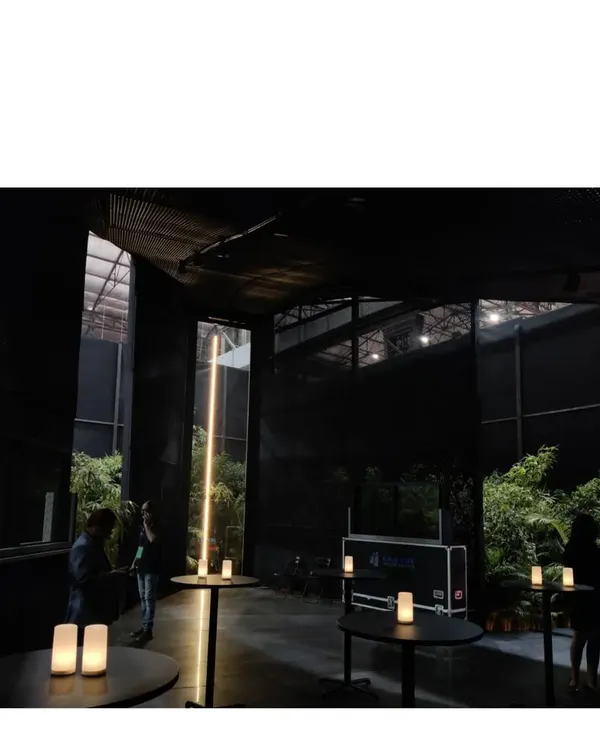 The Durall Pavilion, a black structure designed as a place of pause and peace amidst the cacophony of a product exhibition. It could be a church, a meditation hall, or a garden folly; we designed it to be all of the above.
