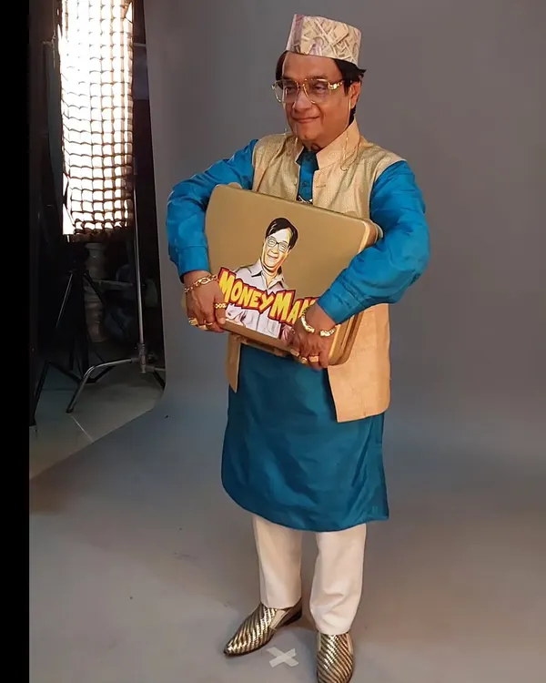 The final look for the 'Money Man' character in a lottery advertisement, played by the wonderful Biju Kalaa. The bright blue kurta, gold waistcoat, and shiny shoes create a fun, aspirational character.