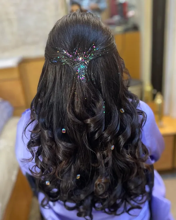 Let your hair do the talking with this sparkling glitter hairdo. I love adding a touch of multi-colored glitter to a half-up style for a fun and festive look, perfect for a sangeet or cocktail party.
