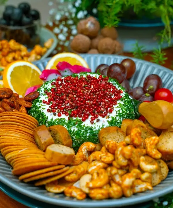 We believe every gathering deserves a stunning centerpiece. This artisanal cheese platter, featuring a dill and pink peppercorn cheese ball, assorted crackers, nuts, and fresh fruit, is designed to be a feast for the eyes and the palate. It’s the perfect way to welcome guests and start conversations.