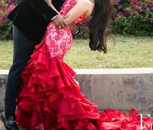 A moment of pure drama and romance. The voluminous, ruffled skirt of this custom red gown creates a stunning visual, perfect for a pre wedding photoshoot or a grand reception entrance.