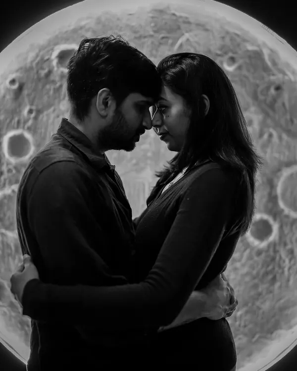 An intimate black and white silhouette of a couple in front of our moon backdrop. This artistic shot focuses on their connection, creating a timeless and romantic image.