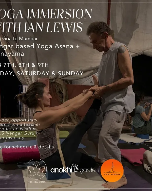 Renowned instructor Ian Lewis from Goa provides hands-on assistance in an Iyengar-based workshop. This image captures a moment of deep learning, focusing on precise alignment and the use of props to refine asanas.