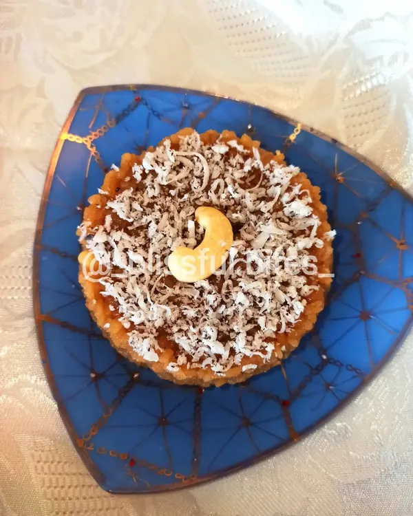This is my Gur Wale Chawal, or jaggery rice, a classic North Indian dessert. It's garnished with shredded coconut and a cashew, offering a wholesome and comforting sweet flavour.