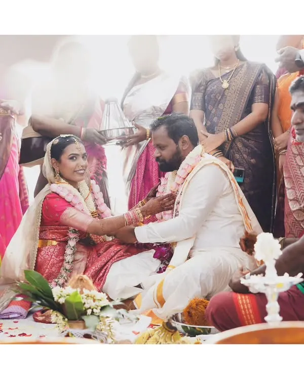 A beautiful moment during a South Indian wedding ceremony. The bride and groom are framed by family, showcasing the community and tradition that are central to the celebration.