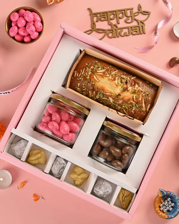 This is my "Shahi" Diwali hamper, a perfect example of what we do. It features our in-house, eggless Mawa Cake, Pink Almond Dragees, Chocolate Coated Cashews, and assorted nut rocks, all packed beautifully in our signature pink box.