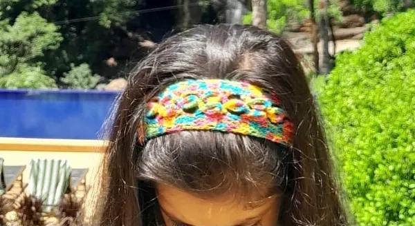 Here is one of my multi-color crochet headbands being worn. It's a comfortable and stylish way to add a pop of color to your look, perfect for any age.