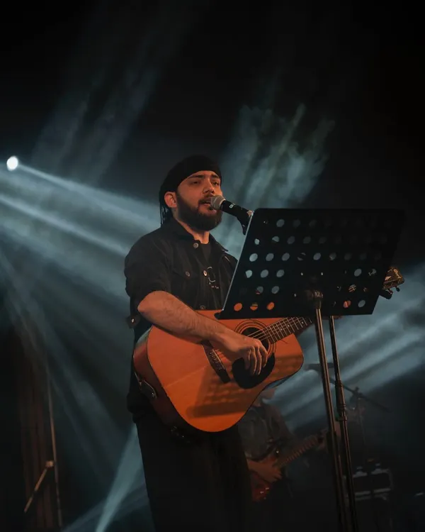 This is where I feel most at home, on stage with my guitar. This shot captures that moment of connection, just me, the music, and the story I'm about to tell. It's the core of my solo acoustic sessions.