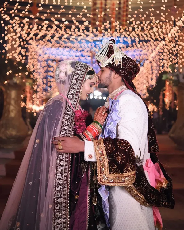A tender moment between the couple, illuminated by a magical bokeh of lights. This is the kind of fairytale romance we love to capture on the wedding day.