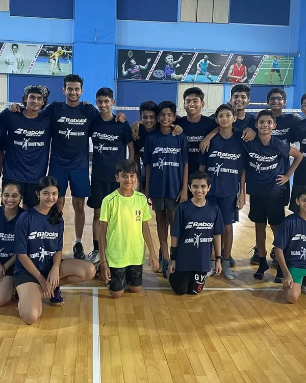 The graduating batch of our 2023 kids' badminton summer camp. Everyone is seen here in their official camp t-shirts, part of the gear every participant receives.