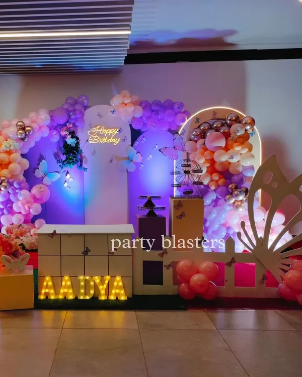 A beautiful butterfly-themed party for Aadya. This setup features a soft pastel color palette, a large butterfly wing cutout, and a neon "Happy Birthday" sign for a touch of modern elegance.