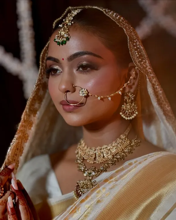 This is the bridal glow I love to create. It's all about enhancing your natural beauty so you feel confident and, most importantly, like yourself on your big day. This look features soft, shimmery eyes, flawless dewy skin, and traditional gold jewellery for a timeless wedding look.