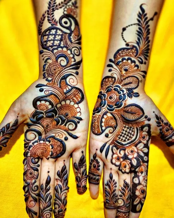 A perfect example of a modern fusion design. This combines the boldness of Arabic mehndi with the intricate fillers of Indian patterns for a stunning result.