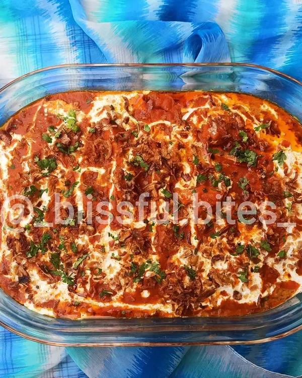 My signature Memon Malai Chicken is special because it's baked, not just simmered. This process locks in the flavors of the red gravy base, and the generous topping of cream, or malai, gives it a luxurious, melt-in-your-mouth texture.