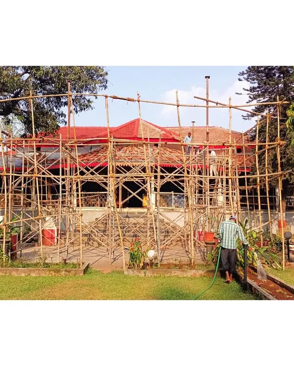 The entire edifice enveloped in scaffolding during the initial phase of restoration. This framework allows us to access and work on every part of the exterior, from the stone masonry walls to the century-old roof.