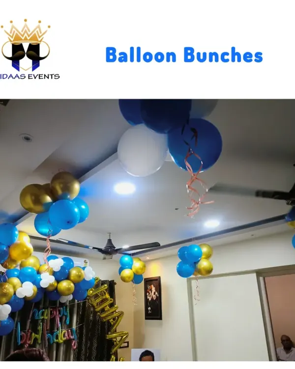 For this home birthday celebration, I used balloon bunches in blue, gold, and white to decorate the ceiling. This is a simple but effective way to add a festive touch to the entire room.