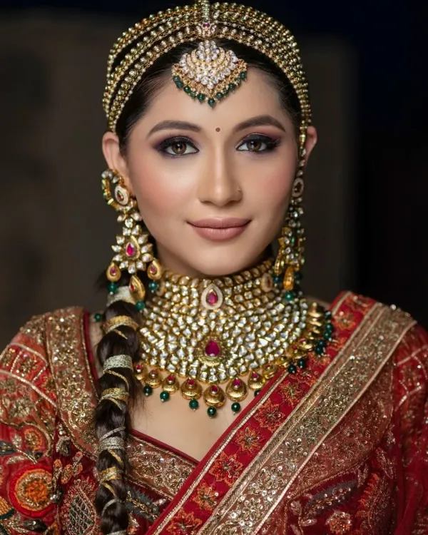 A truly regal bridal portrait. The elaborate matha patti, statement necklace, and smokey eye makeup come together to create a look of pure royalty.