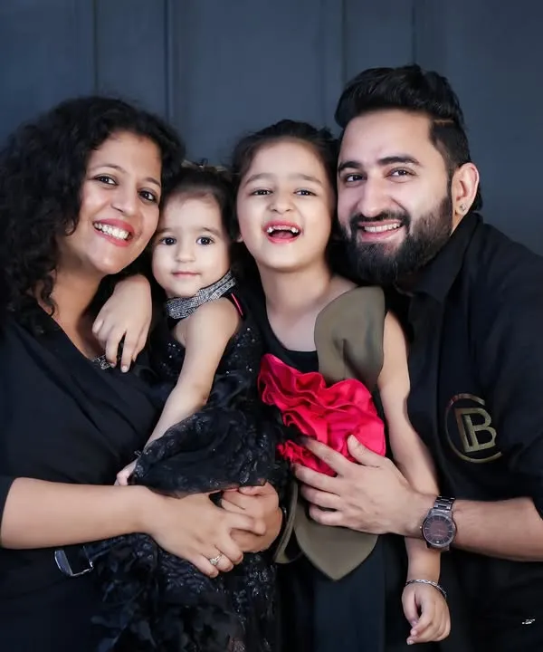 A classic family portrait that radiates happiness. In the studio, with a simple background, all the focus is on your family's smiles and connection. This beautiful family of four shows how timeless these photos can be.