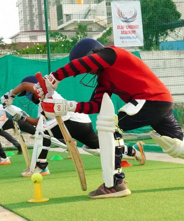 Synchronization and discipline are key. This image captures our students during a group batting drill, all practicing their forward defensive stance together, building muscle memory and technique.