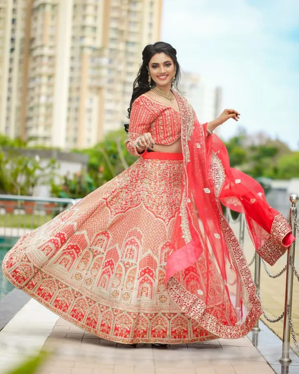 This gorgeous red and beige bridal lehenga, with its intricate embroidery, is one of our most loved rental pieces. It’s perfect for the bride who wants a traditional look with a touch of modern elegance, and we will alter it to fit you perfectly.