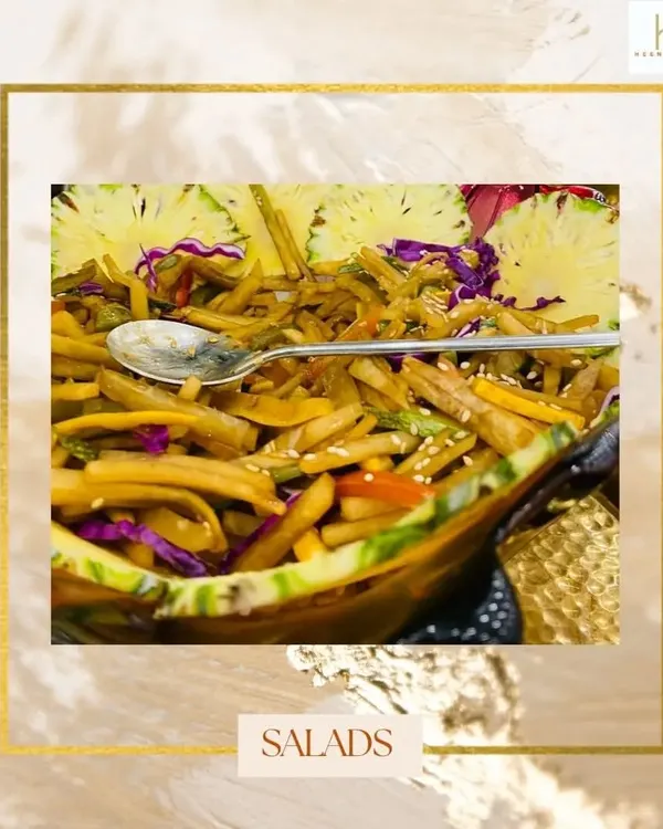 Even salads can be a work of art. Here, a fresh and healthy Jain salad is served in a hollowed-out pineapple, making it both delicious and visually appealing.