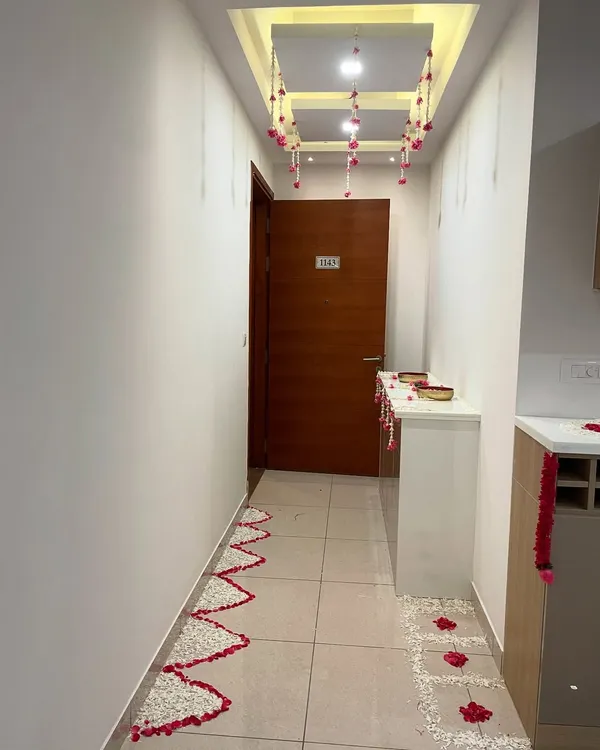 An elegant and simple housewarming decoration for a client's home. I created a pathway of flower petals and hung floral strings from the ceiling to create a warm and welcoming entrance.