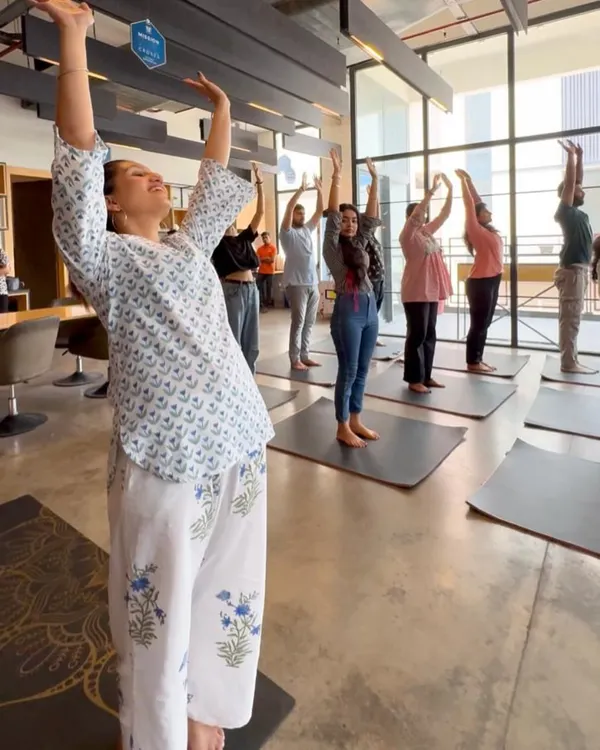 The joy on everyone's face says it all. This is a moment from a corporate yoga session where we focused on simple, uplifting stretches to release tension from the neck, shoulders, and back. You can see how accessible and enjoyable it is for the whole team.
