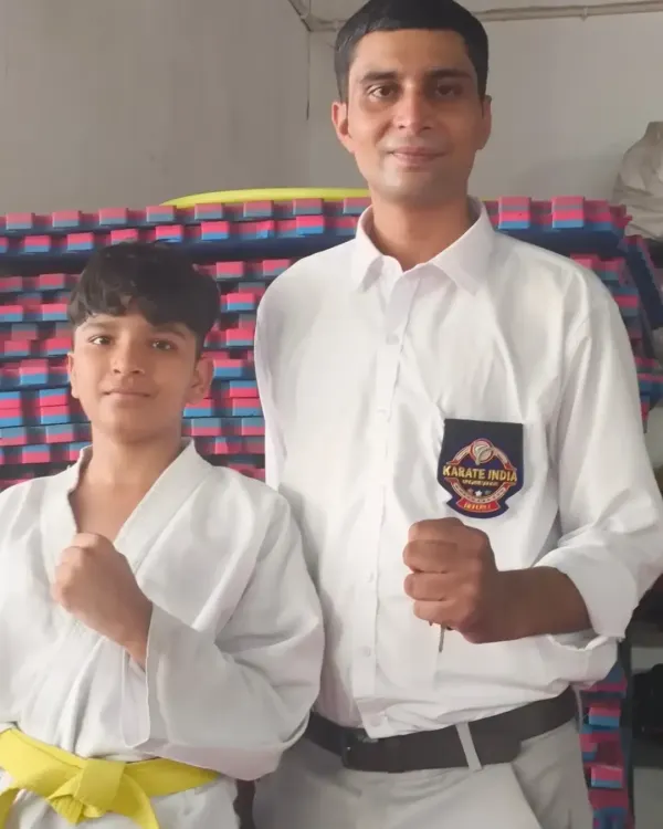 With a young yellow-belt student in the dojo. I am personally invested in the growth of every student.