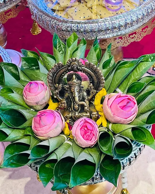 I believe every celebration should start with a blessing. This beautiful brass Ganesha idol, carefully placed on a bed of fresh betel leaves and lotus buds, creates a truly auspicious and divine focal point for your Gruha Pravesha or festival pooja.