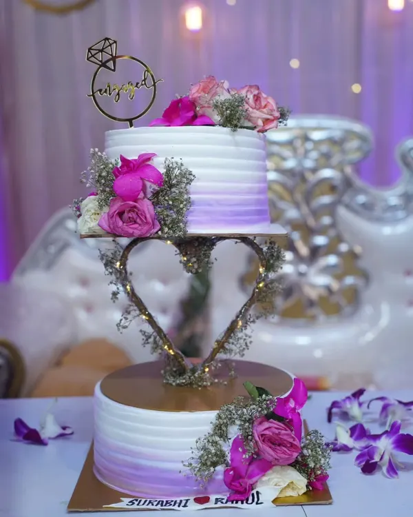 This floating two-tier engagement cake is one of my proudest creations! I used a custom heart-shaped stand with fairy lights to make it look like it's levitating. It’s a perfect centerpiece for your special day, available in my popular Red Velvet or Dutch Chocolate flavors.