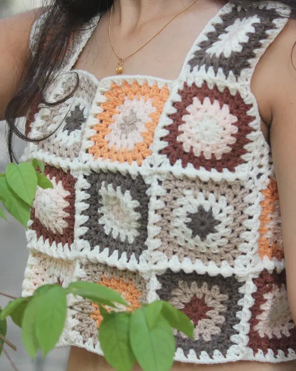 A closer look at the craftsmanship of my granny square top. The earthy tones of brown, beige, and orange are perfect for a vintage-inspired, bohemian look.