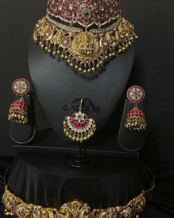 A beautiful and intricate temple jewellery choker with a goddess Lakshmi motif and pearl drops. This piece is perfect for pairing with a silk saree for any traditional occasion.