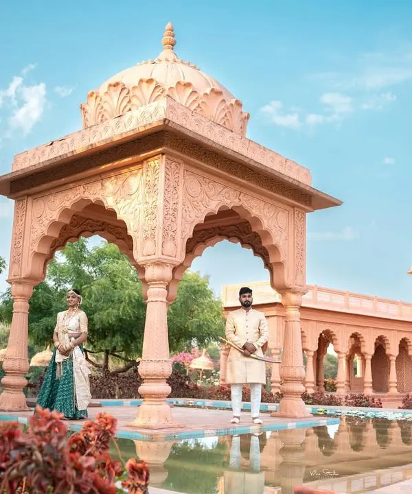A grand, wide-angle shot that establishes the royal theme. I place the couple within the stunning architecture to create a sense of scale and majesty for their pre-wedding photos.