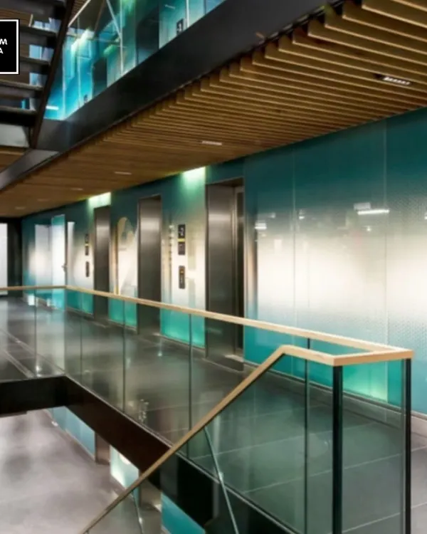 This corporate elevator lobby demonstrates how integrated lighting can define architectural features. We used recessed linear lights and wooden ceiling slats to create a sense of depth and direction, guiding visitors while establishing a sophisticated, modern atmosphere.
