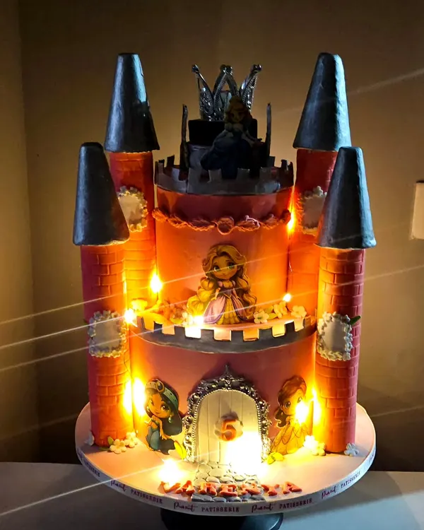 This is where fairytales come to life. I created this magnificent princess castle cake with built-in lights and a rotating crown on top, making it a truly magical and interactive centerpiece for a very special fifth birthday.