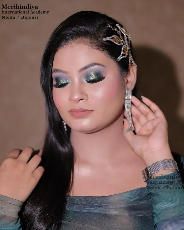 A sleek, modern hairstyle for a party look, featuring a jeweled dragonfly hair clip as a statement accessory.