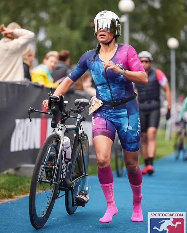 Running with my bike into transition. This is the end of the bike leg, and every second counts. Efficient transitions are a skill we practice repeatedly.