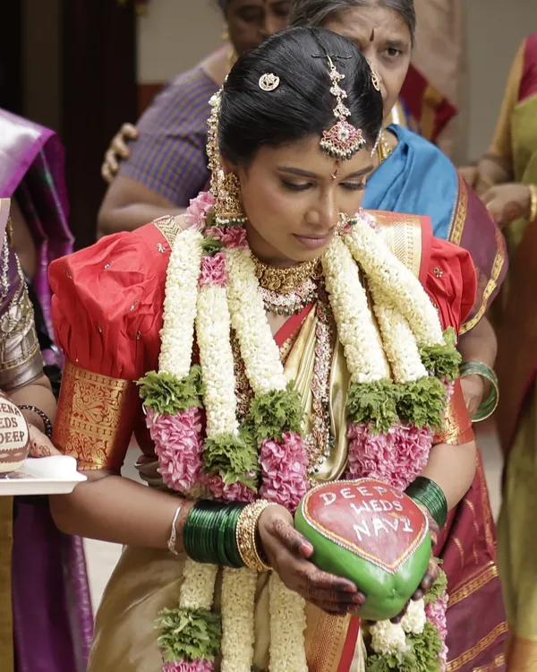 It's a joy to see our work become part of your cherished moments. Here, a beautiful bride holds a coconut we personalized for her wedding ceremony, with the couple's names hand-painted on it.