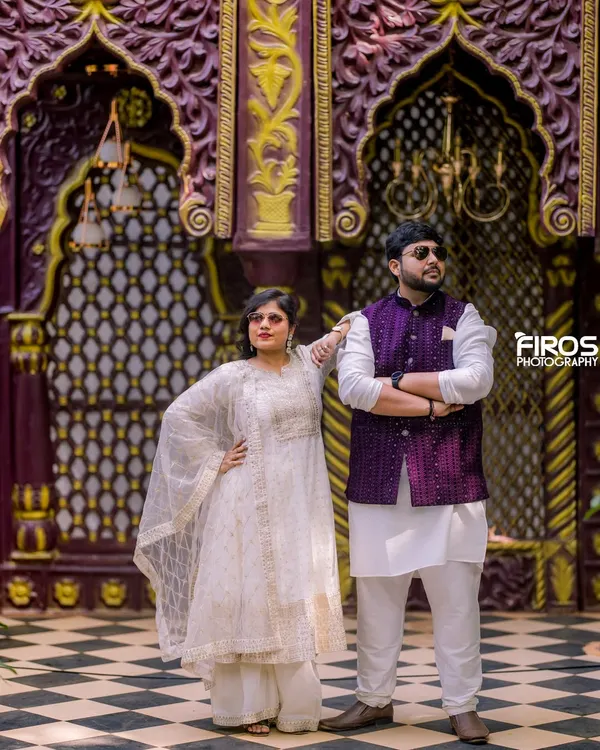 This regal backdrop with intricate purple and gold arches is part of our Jaipuri-inspired collection, perfect for adding a touch of royalty to your pre-wedding or traditional photoshoot.