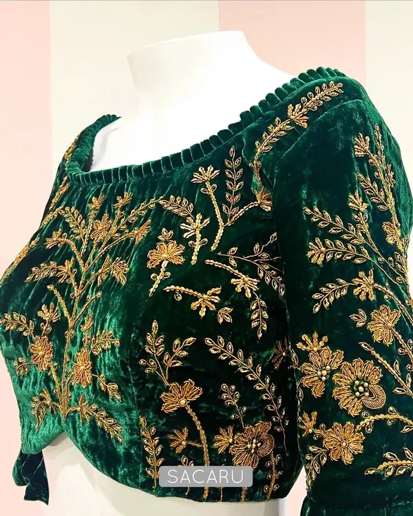 Green velvet and gold zardosi embroidery is a combination that never goes out of style. This blouse features a wide neckline and full-sleeve floral embroidery.