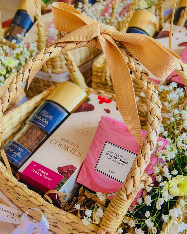 These elegant baskets in a pastel and beige theme are perfect as in-room favors for a corporate retreat or as thank you gifts for conference speakers. Each contains a scented candle, cookies, and coffee.