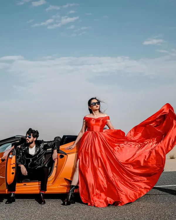 A bold, cinematic statement in the Dubai desert. I love creating these high-impact scenes, using luxury cars and flowing gowns to tell a story of modern romance and glamour against a breathtaking landscape.