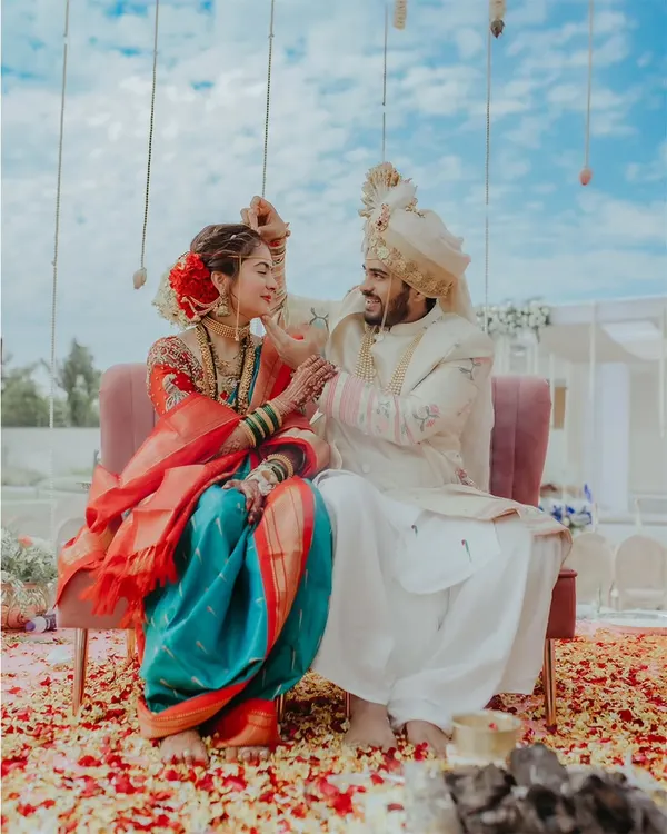 A playful moment between the bride and groom during their Maharashtrian wedding ceremony. Capturing these candid interactions is key to telling an authentic wedding story.