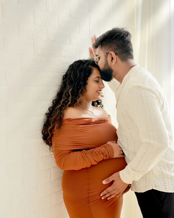 An intimate moment between expecting parents. We focus on capturing the quiet connection and affection in our couples maternity photography sessions.