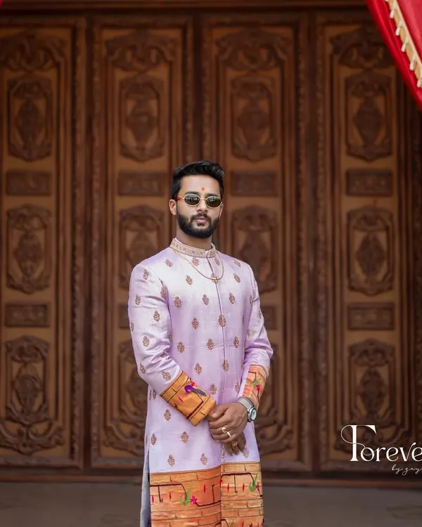 This groom is wearing a custom sherwani I made from Paitani silk. The design features a distinctive woven border and subtle embroidery, showcasing a blend of traditional textile art with a modern silhouette.