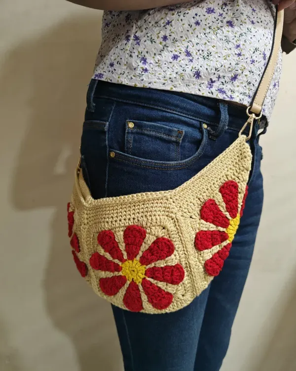 Here is a side view of my Groovy Daisy crossbody bag, showing how comfortably it sits. It's a versatile piece that can also be worn as a fanny pack, making it a practical choice for hands-free convenience.