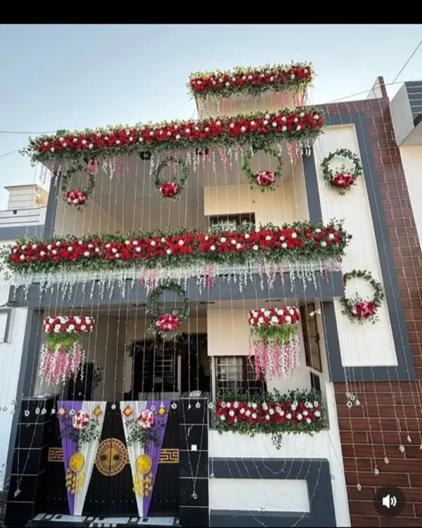 This is how I transform a whole house, or 'kothi', for a wedding. This grand decoration uses thousands of fresh red and white flowers, creating beautiful garlands, hanging arrangements, and wreaths to make the home look festive and welcoming for the special day.