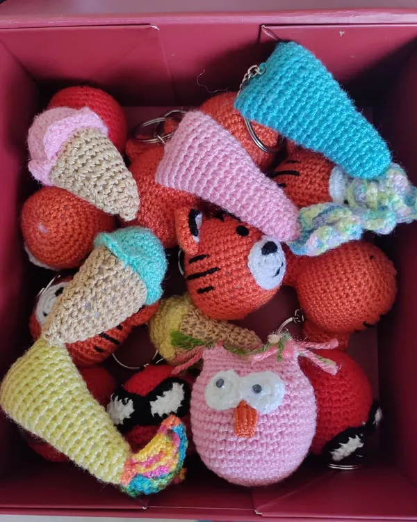 A whole box of happiness! This assortment of custom crochet keychains, including tigers, owls, and ice cream cones, is going out as return favors for a birthday party.