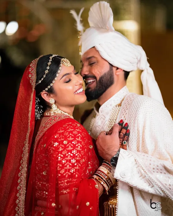 A smile that says it all. This candid close-up captures the groom whispering to his bride, resulting in a moment of pure, unscripted happiness.